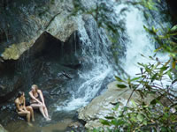 Young ladies at the waterfall base